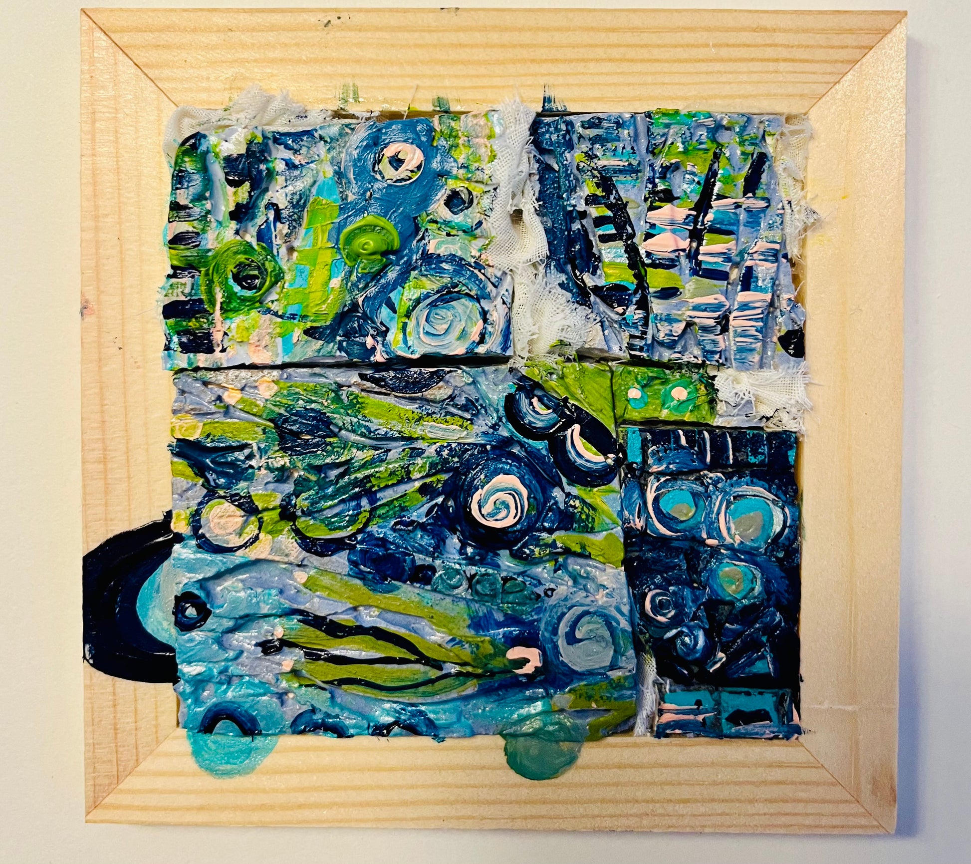 Completed Your Next Era MetaPainting by AFS Mosaics — four hand-cast ceramic Mosaic Evolution Tiles painted in deep blue, green, and black tones, mounted in a wood frame
